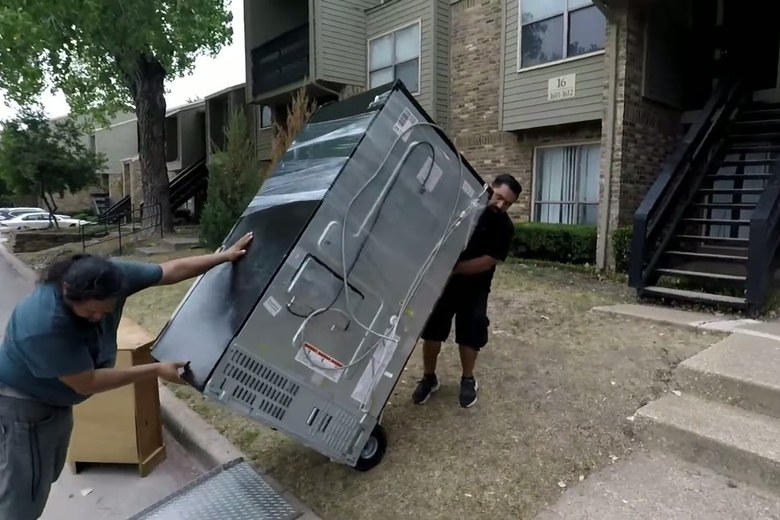Wheeling a fridge out of a Queens apartment